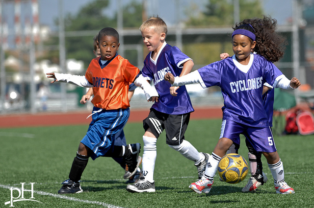 Kids playing soccer.